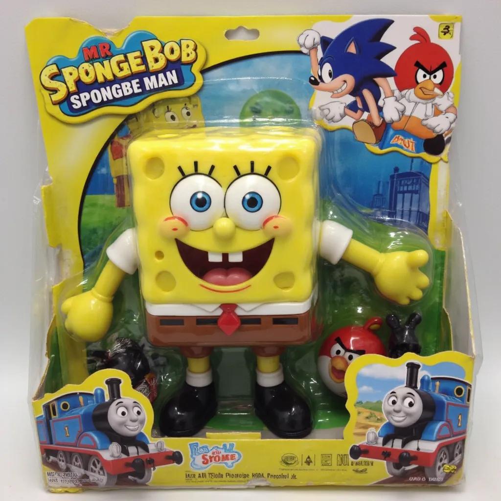 The image is a photograph of a packaged action figure of (spongebob but instead of spongebob its mr sponge man with a collaboration with sonic, angry birds and thomas the tank engine).